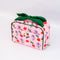 side view of pink quilted toiletry bag with green bow handle and all over periwinkle flower, cherries, bow and lip print