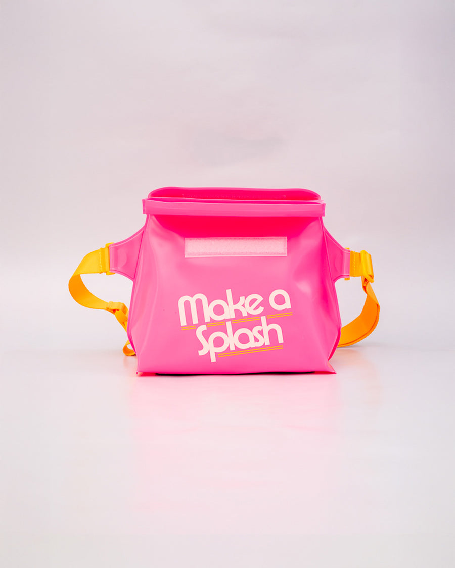 opened pink rubber waterproof bag with white 'make a splash' with yellow strap with velcro closure