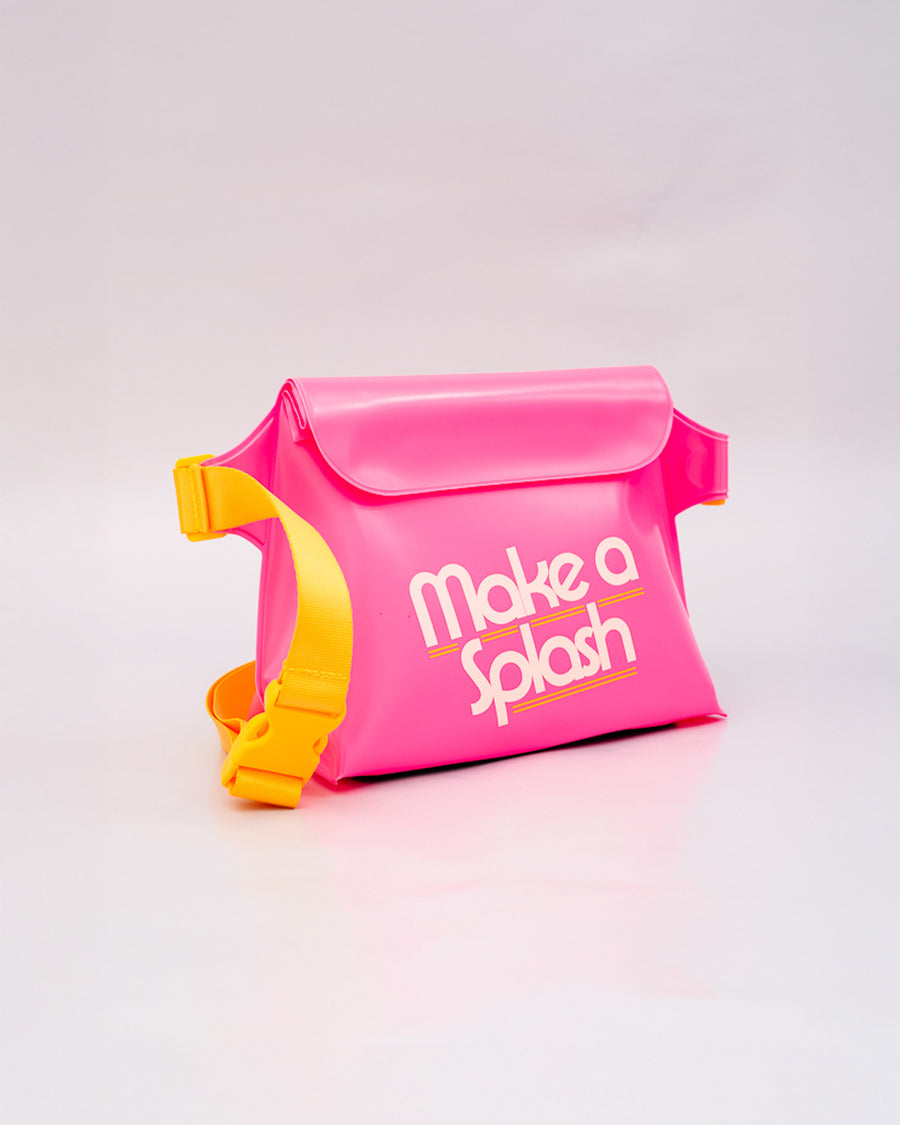 side view of pink rubber waterproof bag with white 'make a splash' with yellow strap