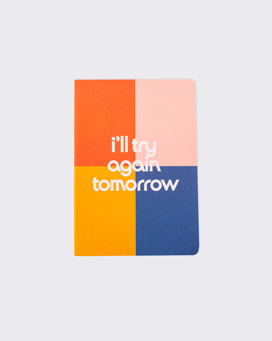 colorblock notebook that says i'll try again tomorrow in white letters