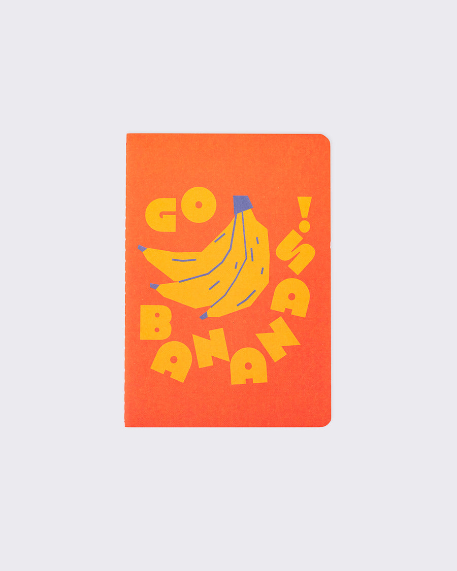 orange notebook with banana illustration that says go bananas in yellow letters