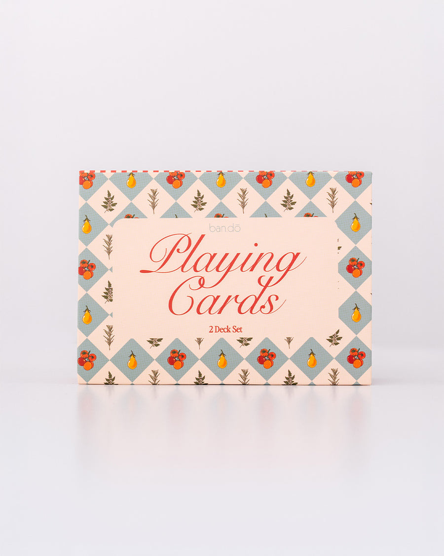 packaged set of two playing card decks with cream and red stripes and blue diamond fruit print