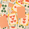 scattered two playing card decks with cream and red stripes and blue diamond fruit print