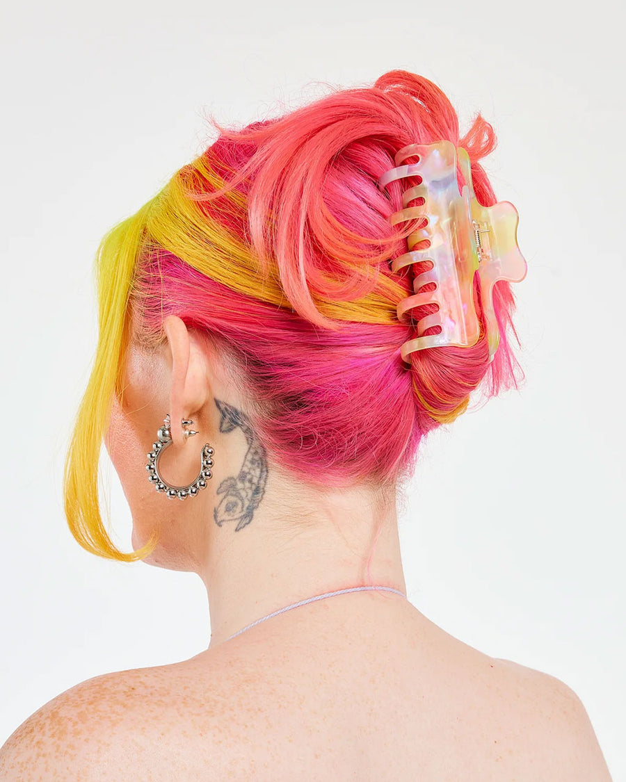 model wearing pastel rainbow large hair claw with double teeth