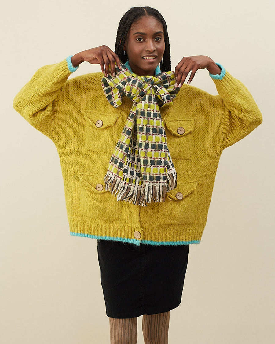 model wearing yellow and green checkered scarf