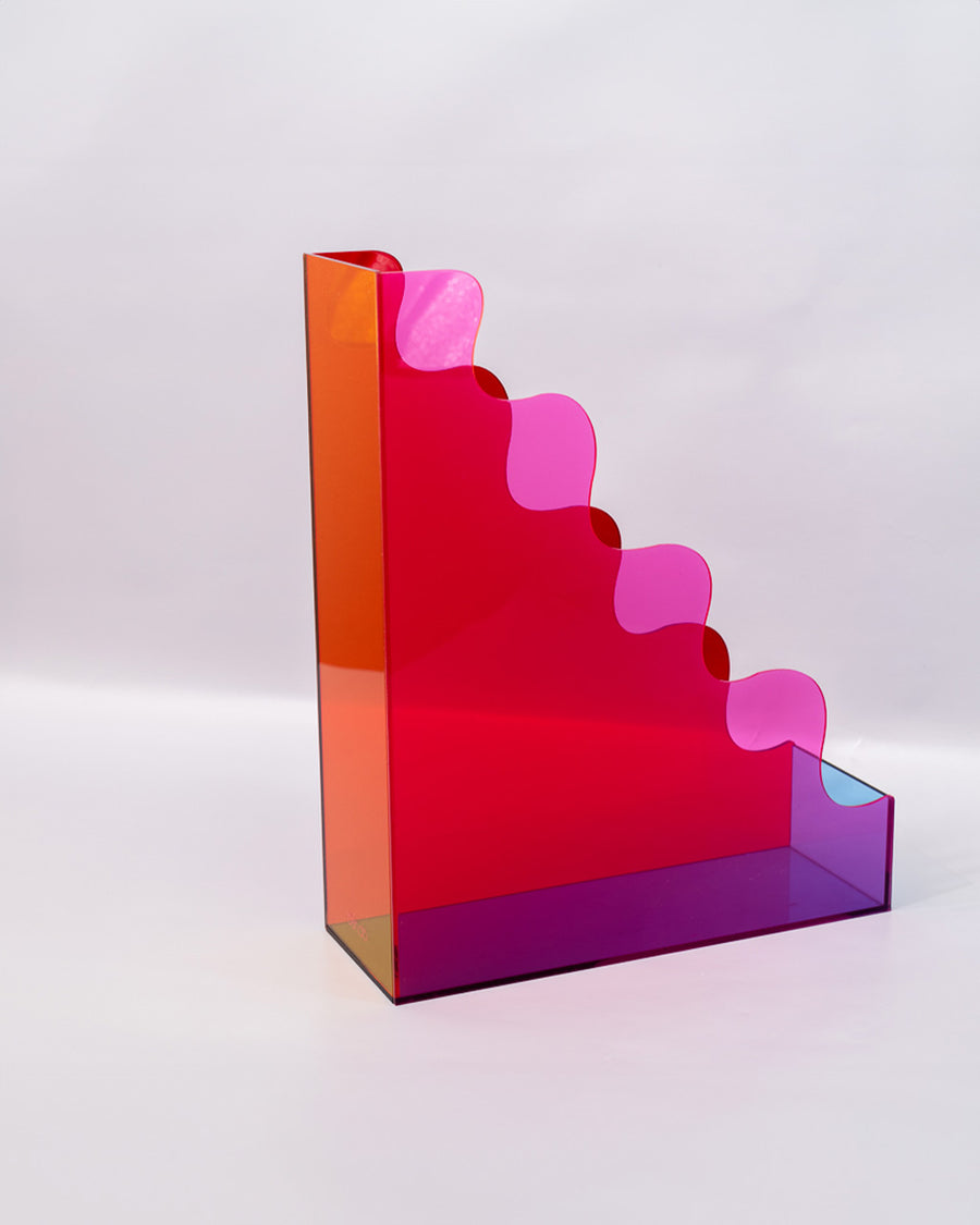 back view of red, pink, yellow and blue acrylic wavy file folder holder