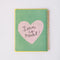 'love is real' graphic inside of white mini notebook with colorful patchwork design (bows, heart, pretzel, strawberry etc)