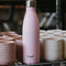 light pink 17 oz stainless steel water bottle on a shelf