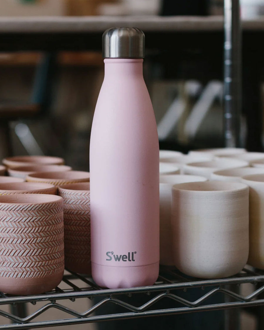 light pink 17 oz stainless steel water bottle on a shelf