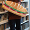 model holding long hoagie shaped throw rug with lettuce, cheese and 'deli meat' center