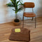 toast and butter shaped throw rug on the floor with chair and plant