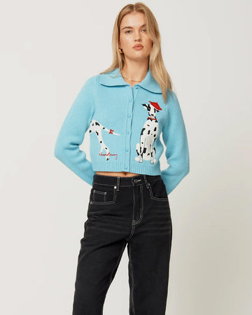 model wearing light blue cropped cardigan with Dalmatian wearing a red beret design wrapping across the side and back