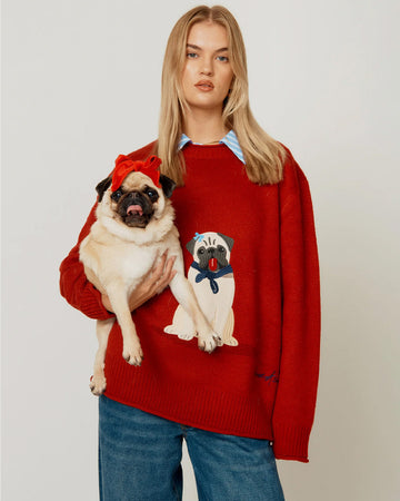 model wearing red oversized crew sweater with pug wearing a blue bow and bandana on the front