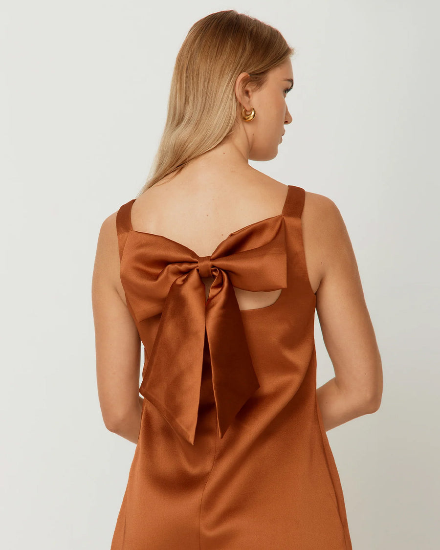 up close of back bow on light brown satin mini dress