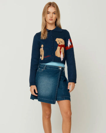 model wearing navy cropped cardigan with cavapoo dog print wearing a red scarf