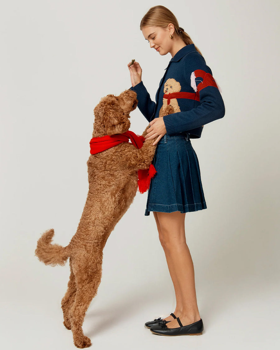 side view of model wearing navy cropped cardigan with cavapoo dog print wearing a red scarf