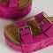 up close of platform suede slide sandals with thick straps and metal buckle closures in fuschia