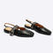 black slingback flat with large grommet buckle and square toe