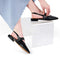 model wearing black slingback flat with large grommet buckle and square toe