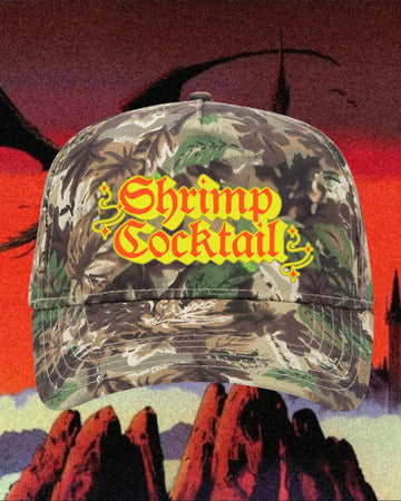 camo snapback hat with yellow and red 'shrimp cocktail' across the front