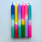 set of six colorful layered tapered candles