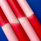 up close of set of 4 red, pink and white layered taper candles