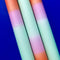 up close of set of 3 orange, mint and pink layered taper candles