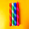 set of 4 diagonally striped taper candles: red/orange, mint/clover green, light blue/royal blue and red/hot pink