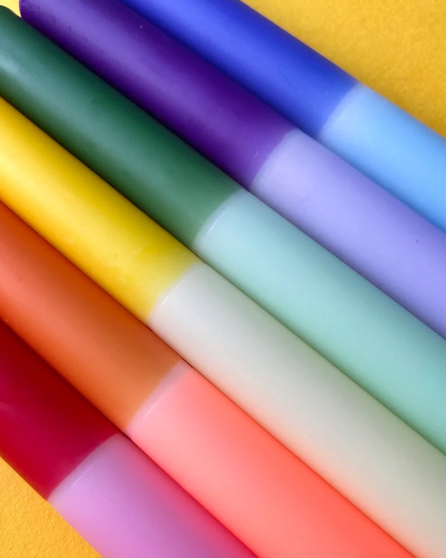 up close of set of 6 colorful two toned taper candles