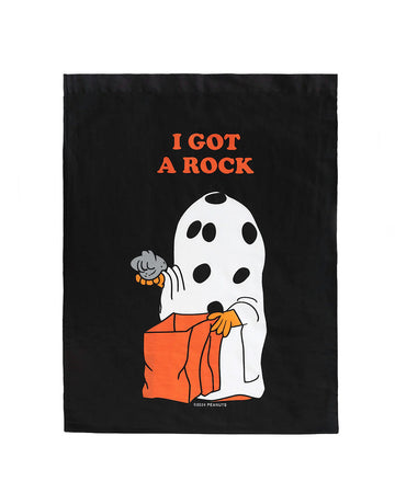 black pillowcase style trick or treat bag with a peanuts character in a ghost costume holding a rock and says 'i got a rock'