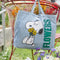 light denim cotton tote with snoopy holding yellow flowers and green 'flowers' on the side on chair