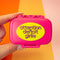 hot pink pill case with yellow 'attention deficit girlie across the front