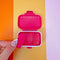 removable piece of hot pink pill case with yellow 'attention deficit girlie across the front