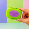 lime green pill case with purple 'depression girlie' across the front