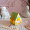 side view of colorful dog house shaped match box with pink tipped matches