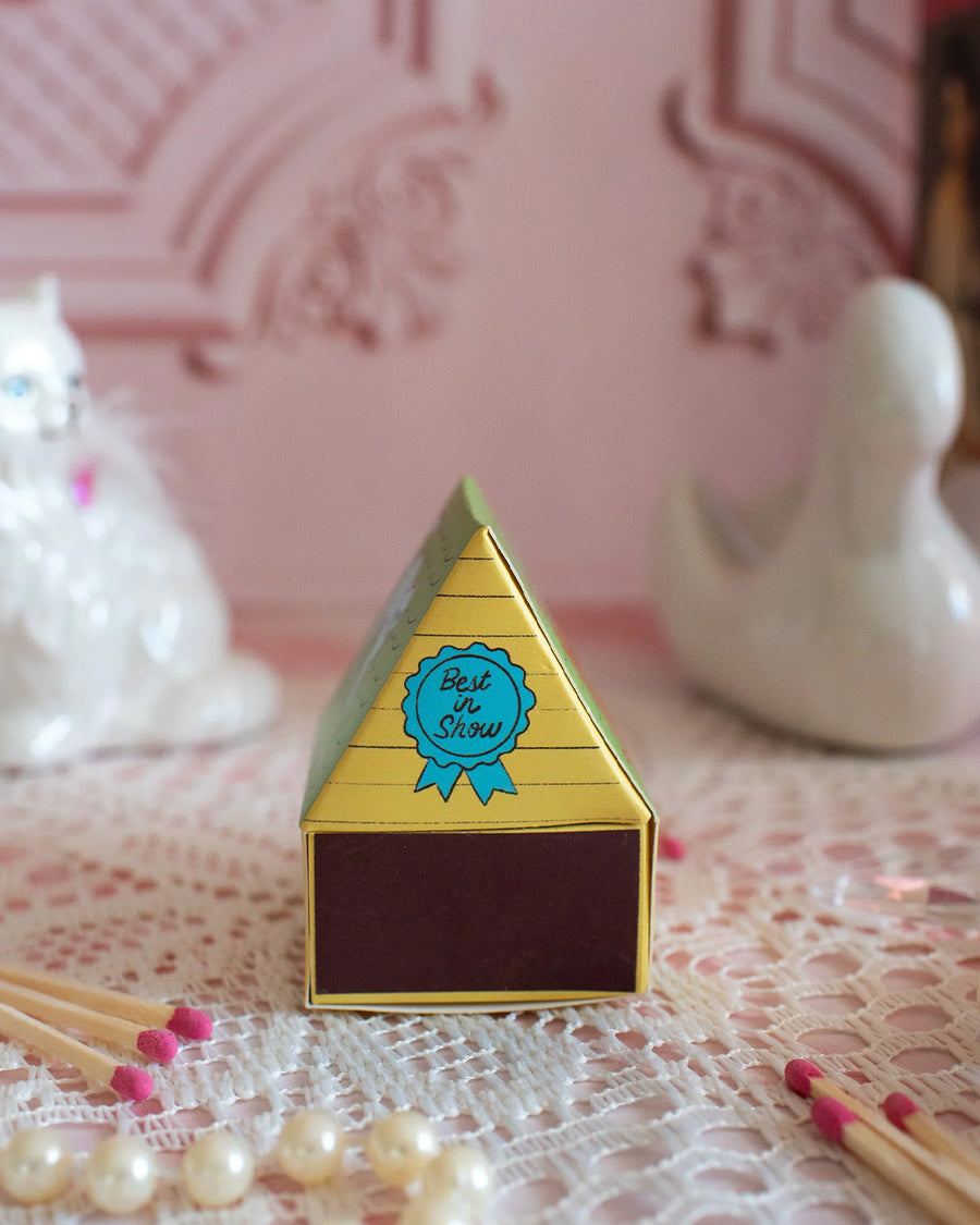 back striker of colorful dog house shaped match box with pink tipped matches