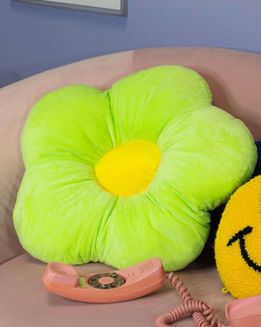 up close of green plush flower shaped throw pillow