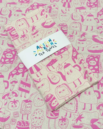 packaged tea towel with pink food face print