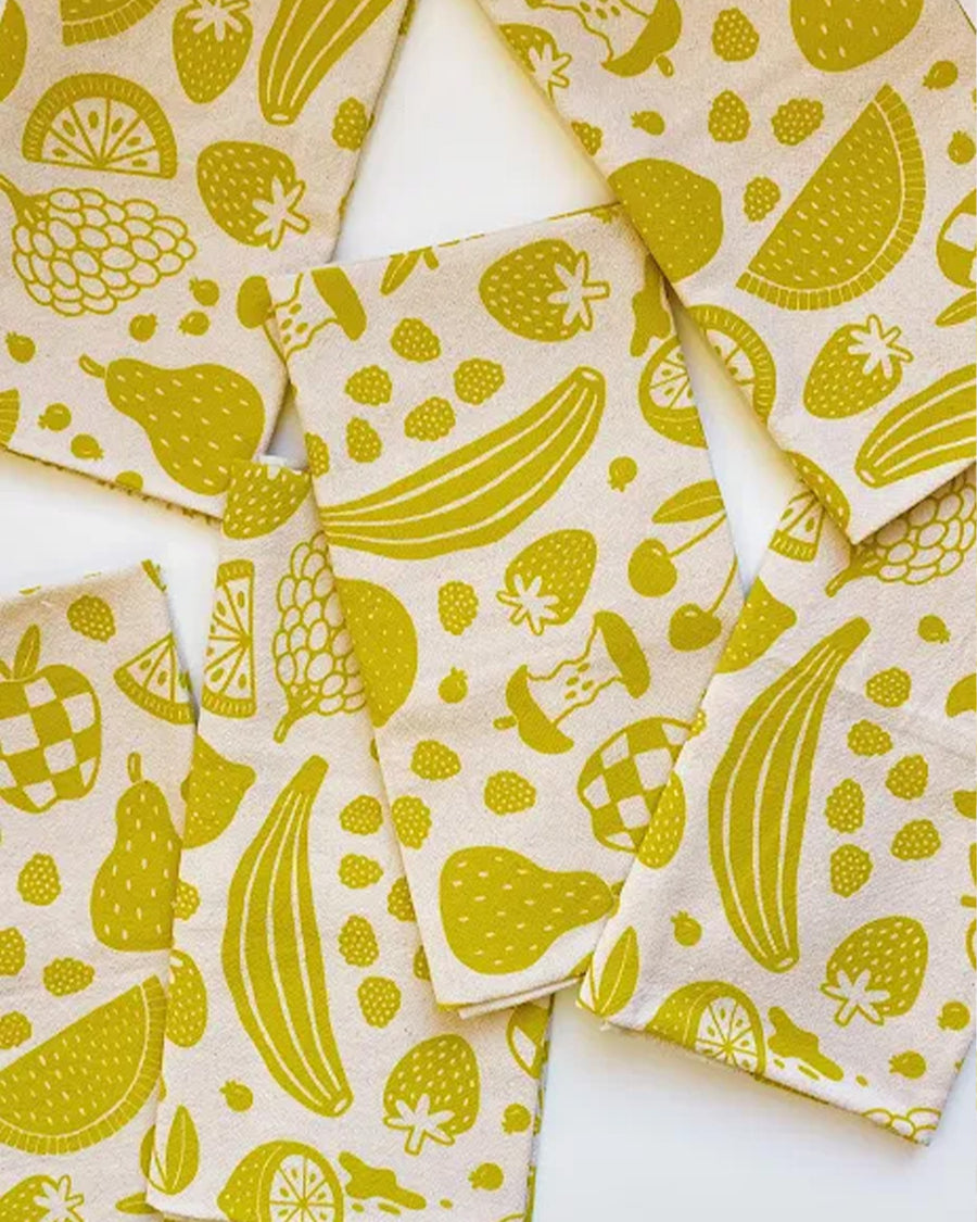 folded mustard yellow fruit print tea towel