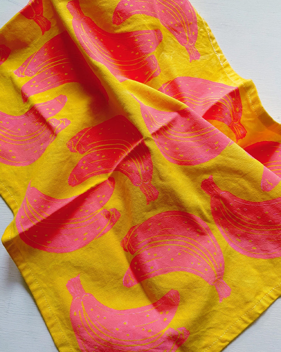 yellow tea towel with hot pink stamped bandana print