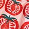 up close of pink tea towel with stamped tomato print