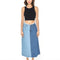 model wearing black tank and light blue and medium blue denim maxi skirt with raw hem waistband