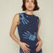 up close of model wearing blue midi dress with all over light blue handprint pattern