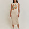 model wearing cream midi knit dress with knitted orange branch print