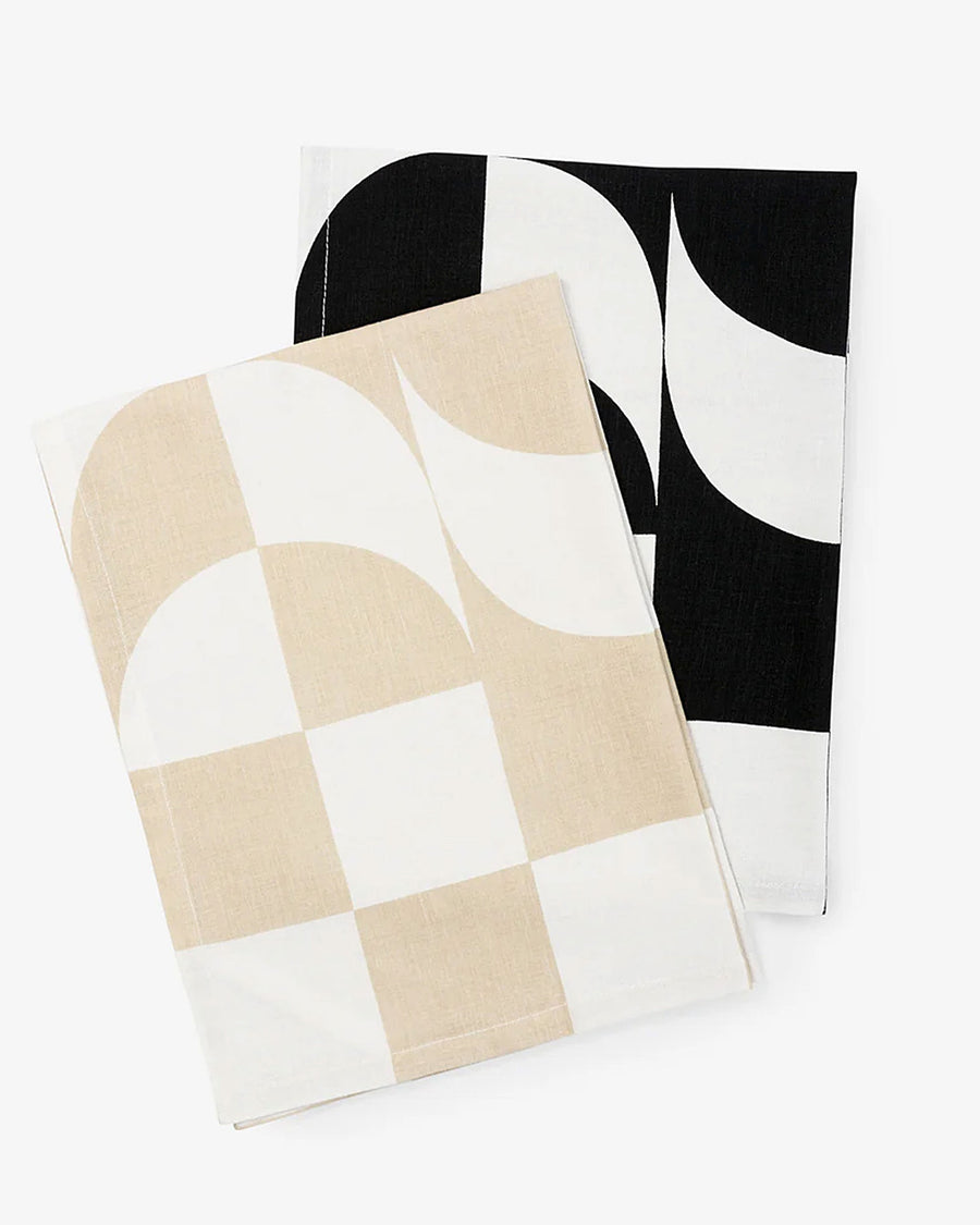 folded set of two trippy checkered hand towels: tan and white and black and white