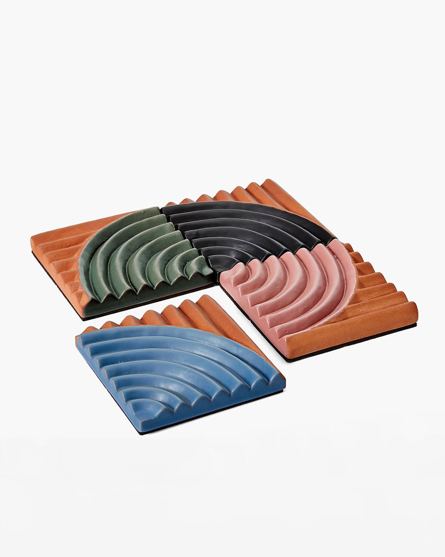 set of 4 terracotta coasters with colorful ribbed detail