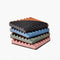 stacked set of 4 terracotta coasters with colorful ribbed detail