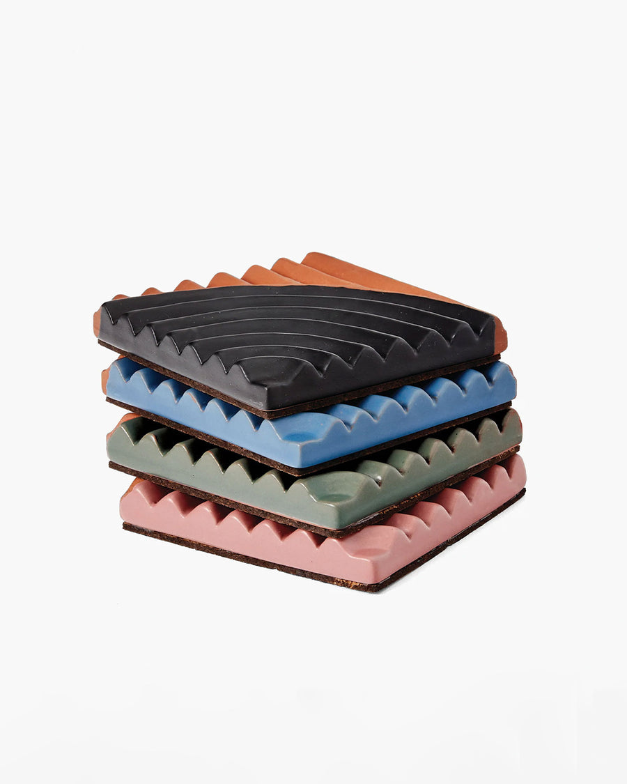 stacked set of 4 terracotta coasters with colorful ribbed detail