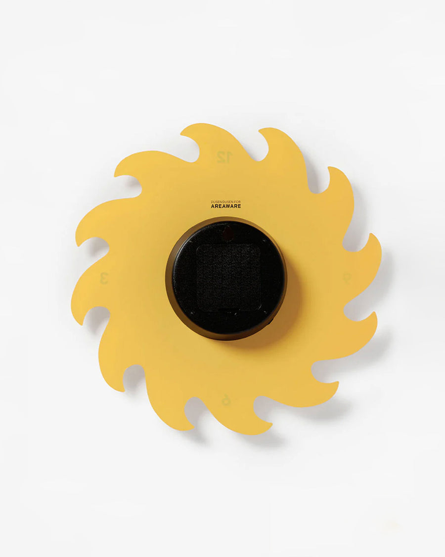 back view of spinning yellow sun wall clock with face