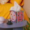 striped tissue box cover with colorful faces on a table